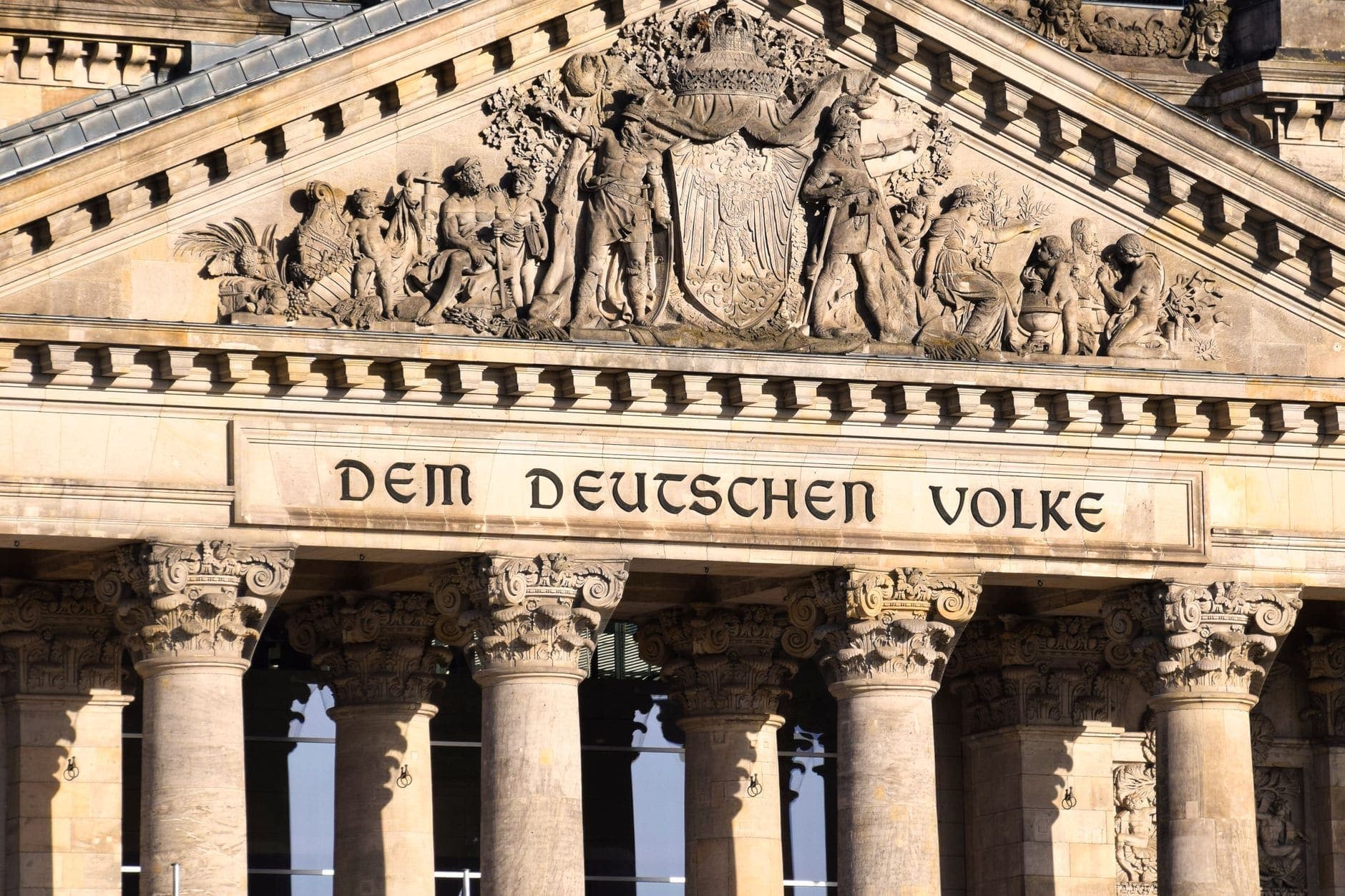 Close-up of the Reichstag facade in Berlin featuring ornate reliefs and columns.
